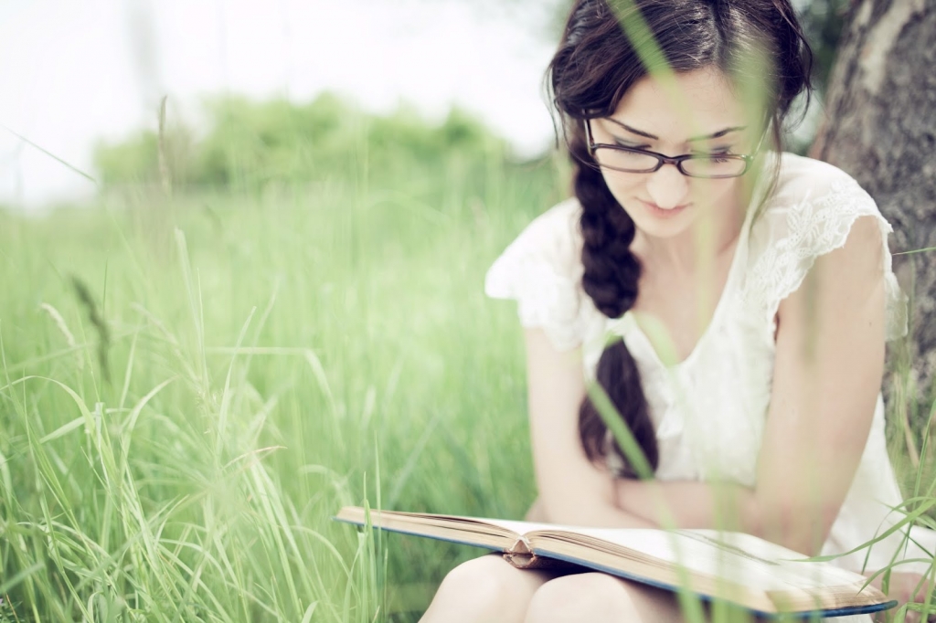 girl reading in field